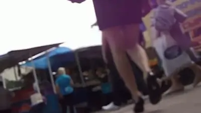 Black hair woman in a blue shirt underskirt video