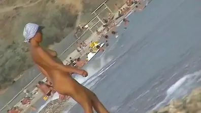 Naked amateur staying in water on beach hunter